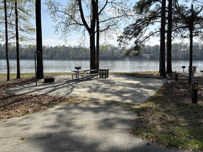 A photo of Site 080 of Loop CVIE at WHITE OAK (CREEK) CAMPGROUND with Picnic Table, Electricity Hookup, Fire Pit, Shade, Waterfront, Lantern Pole, Water Hookup