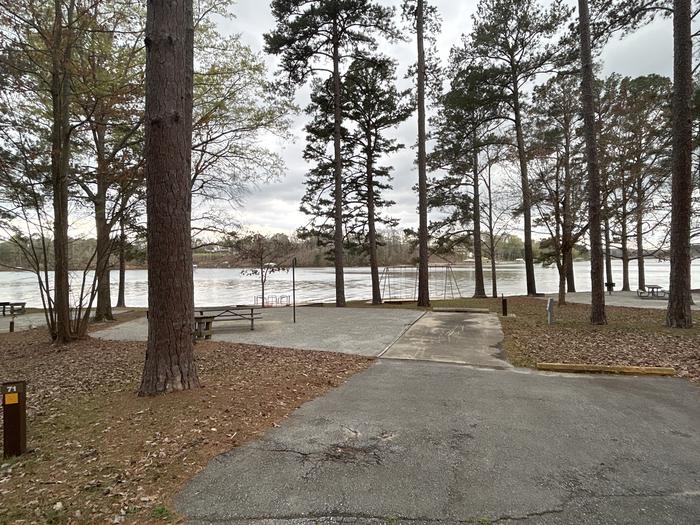 A photo of Site 071 of Loop CVIE at WHITE OAK (CREEK) CAMPGROUND with Picnic Table, Electricity Hookup, Fire Pit, Shade, Waterfront, Lantern Pole, Water Hookup