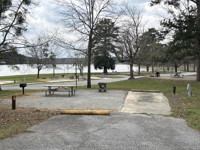 A photo of Site 057 of Loop OAKW at WHITE OAK (CREEK) CAMPGROUND with Picnic Table, Electricity Hookup, Fire Pit, Waterfront, Lantern Pole, Water Hookup