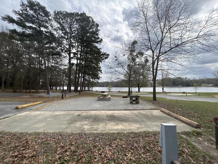 A photo of Site 057 of Loop OAKW at WHITE OAK (CREEK) CAMPGROUND with Picnic Table, Electricity Hookup, Fire Pit, Waterfront, Lantern Pole, Water Hookup