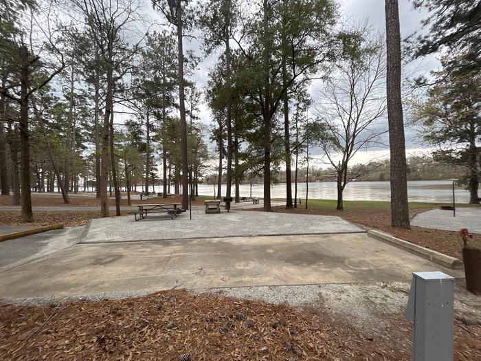 A photo of Site 066 of Loop CVIE at WHITE OAK (CREEK) CAMPGROUND with Picnic Table, Electricity Hookup, Fire Pit, Shade, Waterfront, Lantern Pole, Water Hookup