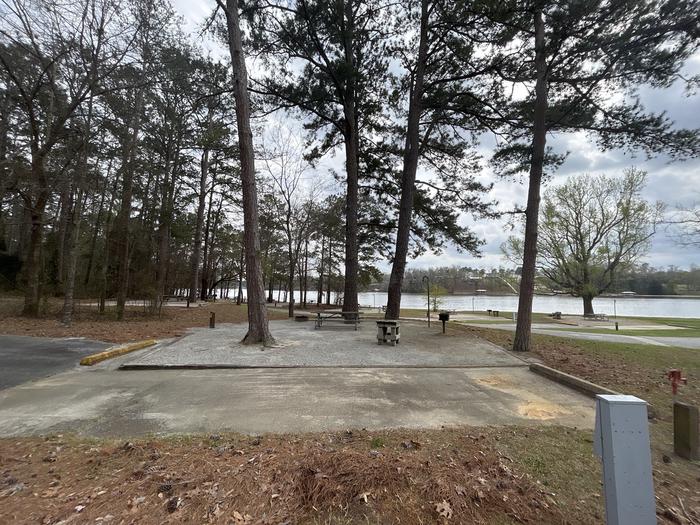 A photo of Site 058 of Loop OAKW at WHITE OAK (CREEK) CAMPGROUND with Picnic Table, Electricity Hookup, Fire Pit, Shade, Waterfront, Lantern Pole