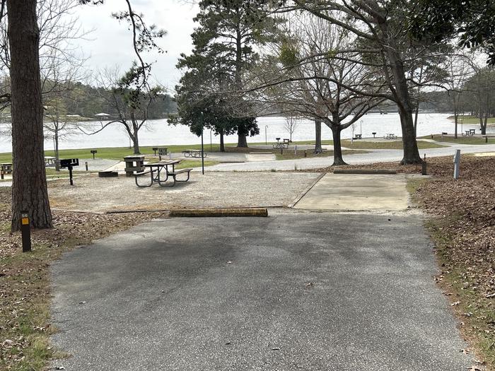 A photo of Site 056 of Loop OAKW at WHITE OAK (CREEK) CAMPGROUND with Picnic Table, Electricity Hookup, Fire Pit, Waterfront, Lantern Pole, Water Hookup