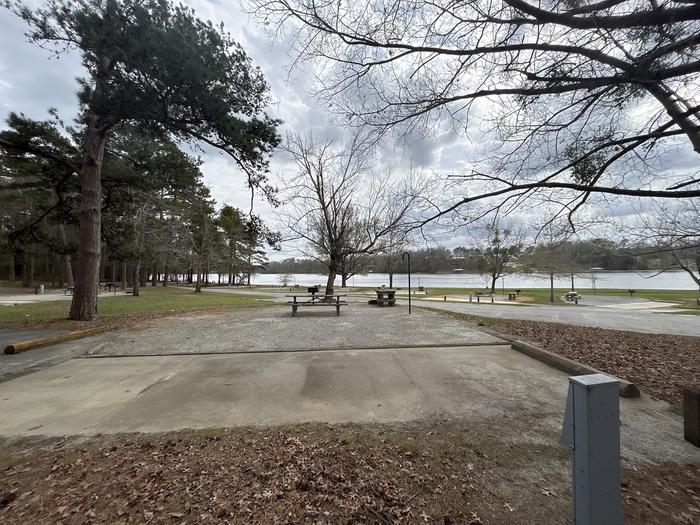 A photo of Site 056 of Loop OAKW at WHITE OAK (CREEK) CAMPGROUND with Picnic Table, Electricity Hookup, Fire Pit, Waterfront, Lantern Pole, Water Hookup