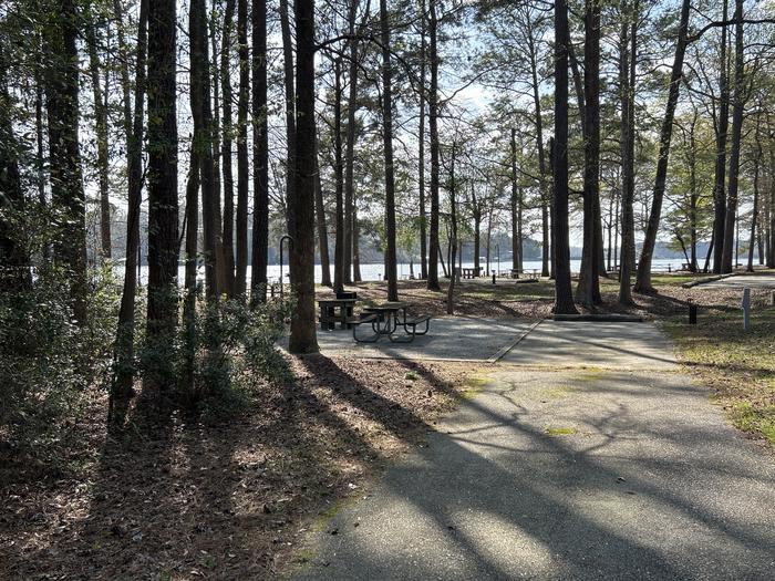 A photo of Site 084 of Loop CVIE at WHITE OAK (CREEK) CAMPGROUND with Picnic Table, Electricity Hookup, Fire Pit, Shade, Waterfront, Lantern Pole, Water Hookup