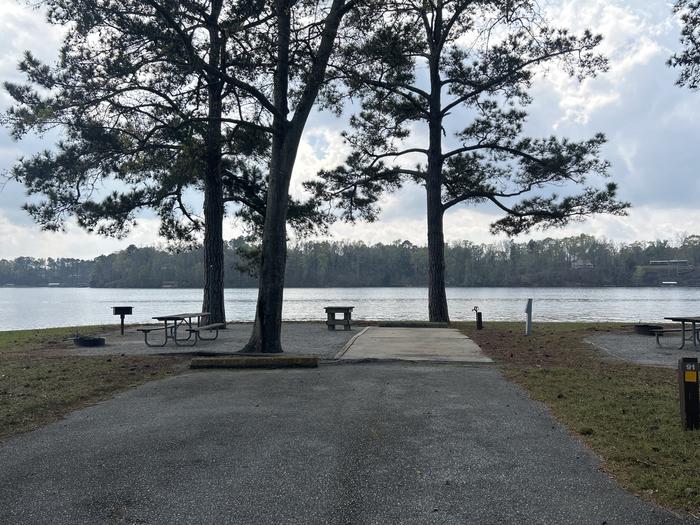 A photo of Site 091 of Loop CVIE at WHITE OAK (CREEK) CAMPGROUND with Picnic Table, Electricity Hookup, Fire Pit, Shade, Waterfront, Lantern Pole, Water Hookup