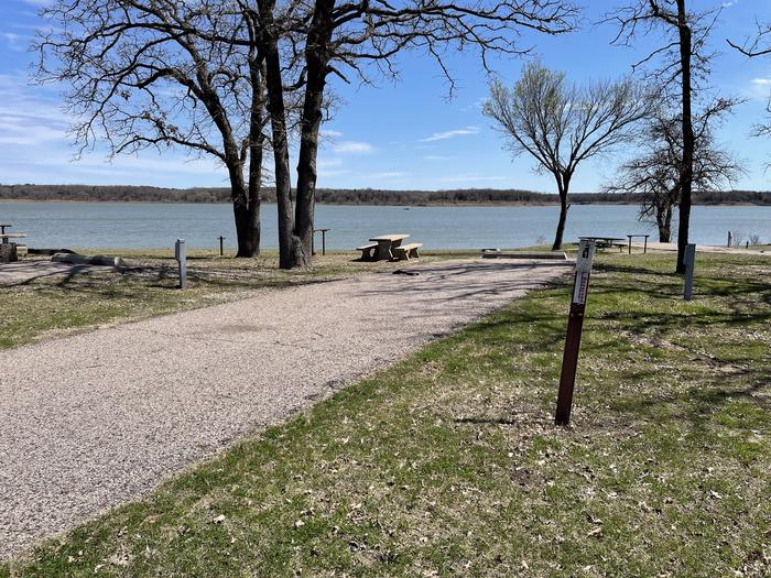 A photo of Site F01 of Loop F at LAKESIDE (OK) with Picnic Table, Electricity Hookup, Fire Pit, Waterfront, Water Hookup