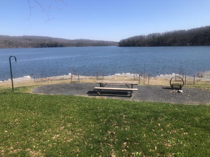 A photo of Site 63- near water of Loop SUSQUEHANNOCK at SUSQUEHANNOCK with Picnic Table, Fire Pit, Tent Pad, Waterfront, Lantern Pole