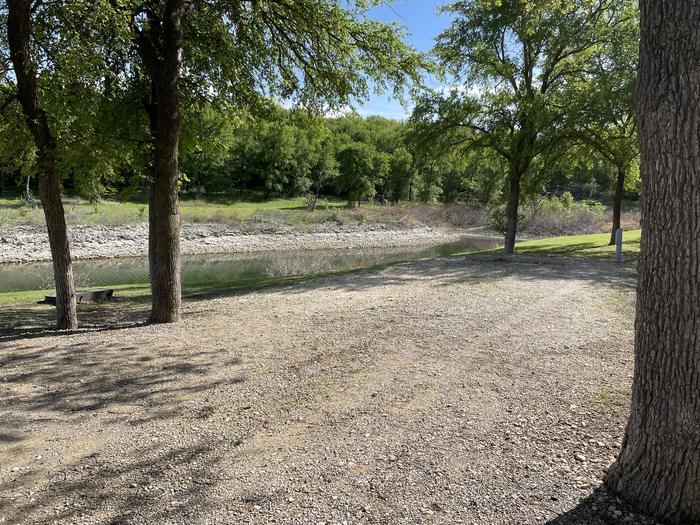 A photo of Site A20 of Loop A at CANEY CREEK with Picnic Table, Electricity Hookup, Fire Pit, Shade, Waterfront, Water Hookup