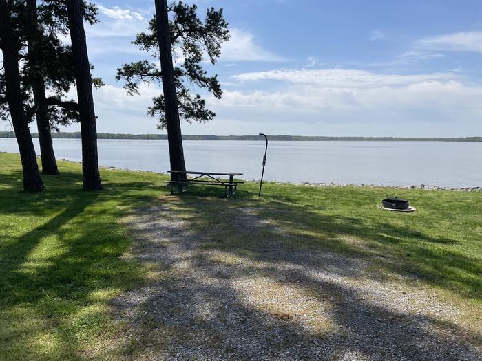 A photo of Site E-8 of Loop E at Crab Orchard Campground with Picnic Table, Fire Pit, Shade, Tent Pad, Waterfront, Lantern Pole