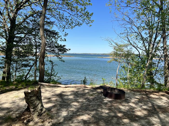A photo of Site G10 campfire ring and scenic view of Paradise Grove at Pax River Paradise Grove Campgrounds with Picnic Table, WaterfrontA photo of Site G10 of Loop Paradise Grove at Pax River Paradise Grove Campgrounds with Picnic Table, Waterfront