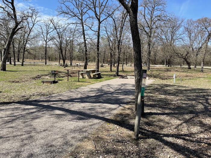 A photo of Site F24 of Loop F at LAKESIDE (OK) with Picnic Table, Electricity Hookup, Fire Pit, Shade, Water Hookup