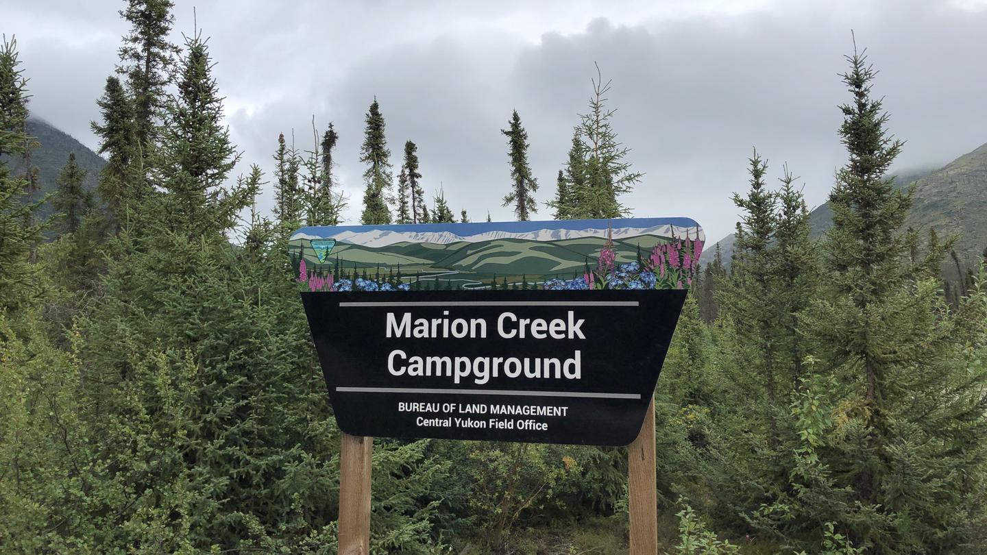 Marion Creek Campground Portal Sign with trees and mountains in the backgroundMarion Creek Campground is located 65 miles north of the Arctic Circle near Coldfoot, Alaska.