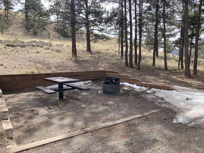 Campsite in the trees with picnic table and fire pit.A photo of Site 023 with Picnic Table, Fire Pit
