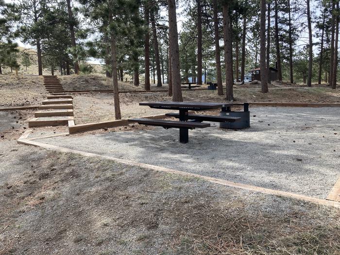 Campsite in the trees with picnic table and fire pit.A photo of Site 019 with Picnic Table, Fire Pit