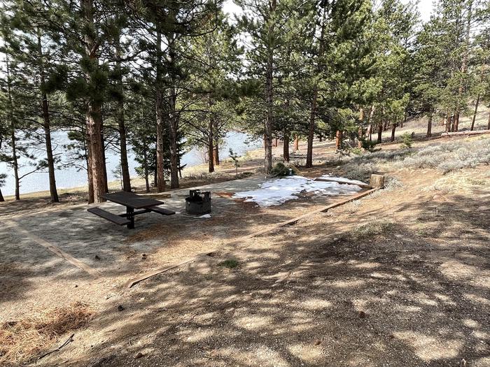 Campsite in the trees with picnic table and fire pit.A photo of Site 032 with Picnic Table, Fire Pit, Shade