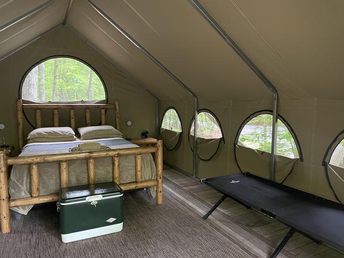 Cot, queen bed and cooler in every tent 
