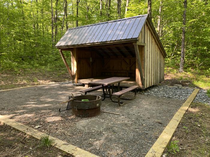 A photo of Site 6 of Loop  at Grout Pond Campground with Picnic Table, Fire Pit, Shade, Tent Pad, Lean To / Shelter