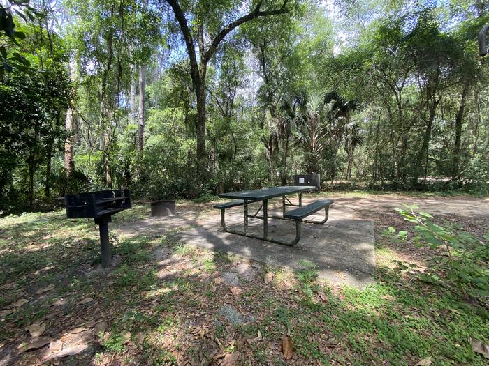 A photo of facility Big Bass Campground (FL) with Picnic Table, Fire Pit, Shade, Lantern Pole