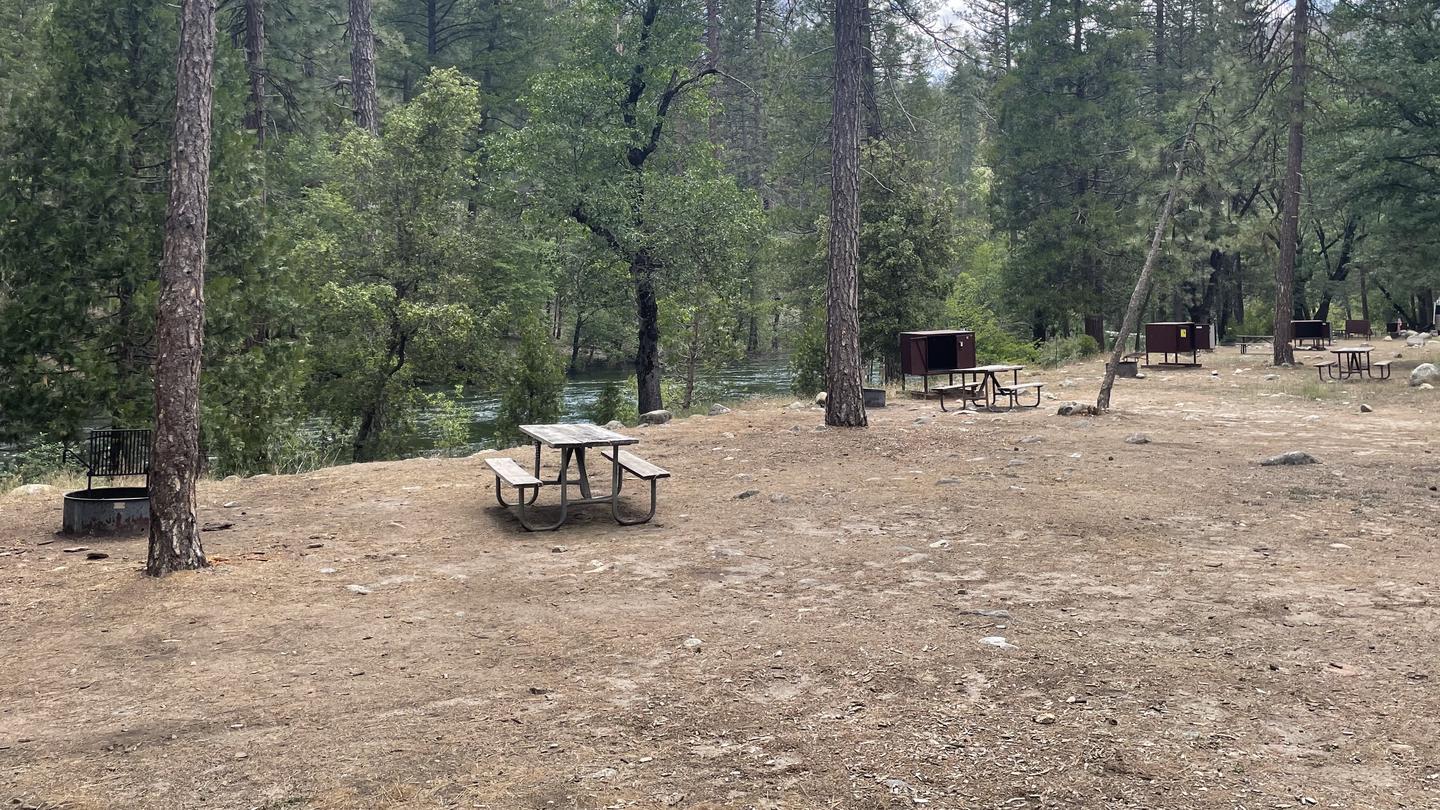 Campsites in C-Loop along river.Campsites along river showing food lockers, table and fire ring. 