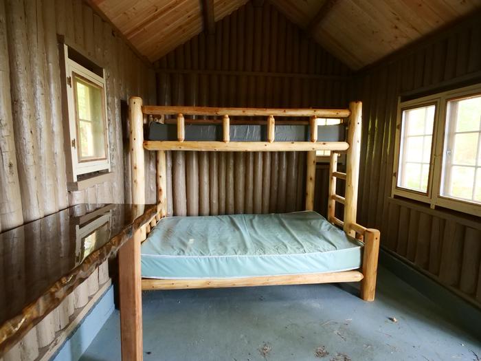Wooden bunkbeds inside of a cabin. (Right).Wooden bunkbeds inside of a cabin.