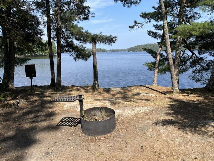 View looking out from campsite over the water with the fire ring in the foreground.View looking out from campsite.