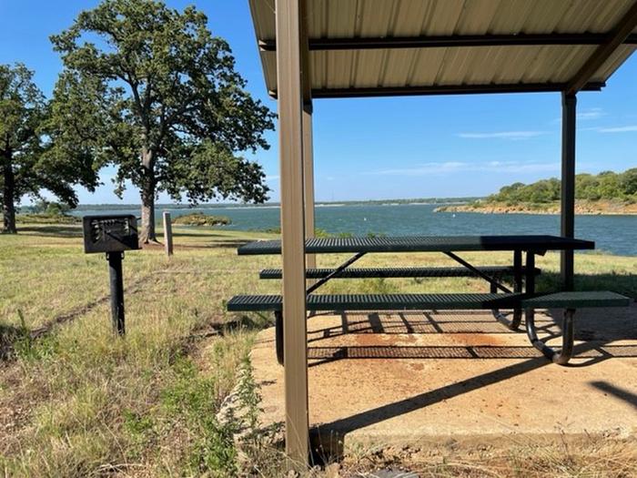 Site 29site 29's view of Grapevine Lake. with a picnic shelter, fire pit, and stand up grill. 