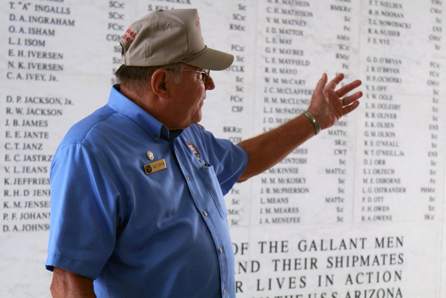 Man points to names on a wallLearn more about the Pearl Harbor story, from park rangers and volunteers