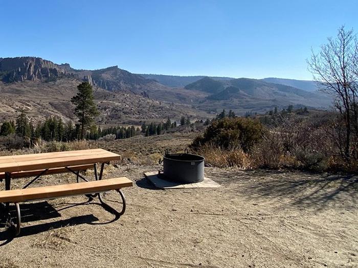 An amazing view from Ponderosa Campground showing a picnic table and firepit in the foregroundAn amazing view from Ponderosa Campground