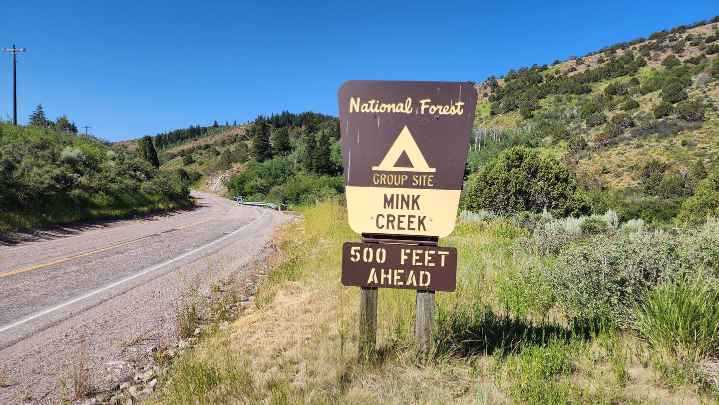 The sign alerting drivers to Mink Creek's entrance