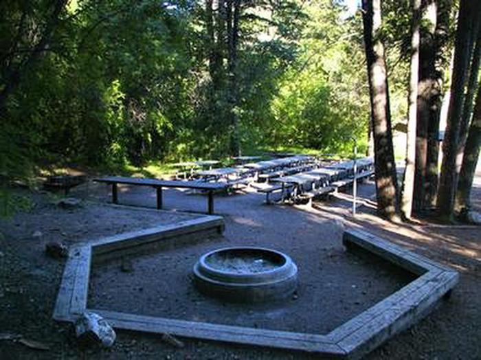 A fire pit and picnic benches at Malad Summit