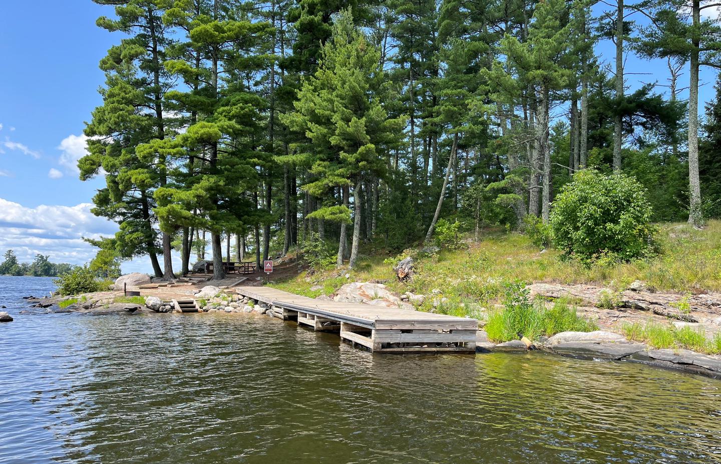 View of dock landing from water with the campsite core in the background.View of dock landing from water
