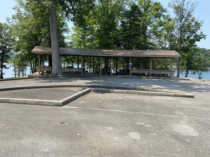 A photo of Site A100 of Loop CPOI at CUMBERLAND POINT CAMPGROUND with Picnic TableA photo of Site A100 of Loop CPOI at CUMBERLAND POINT CAMPGROUND with 6 Picnic Tables, 1 serving table, 2 large grills, benches around outer edge for seating, trash cans & electricity. 