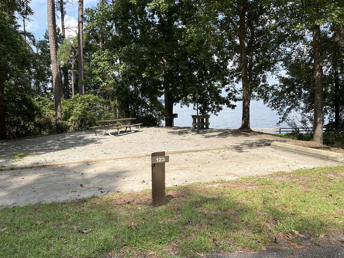 A photo of Site 123 of Loop RCHA at WHITE OAK (CREEK) CAMPGROUND with Picnic Table, Electricity Hookup, Sewer Hookup, Fire Pit, Shade, Tent Pad, Full Hookup, Waterfront, Lantern Pole, Water Hookup