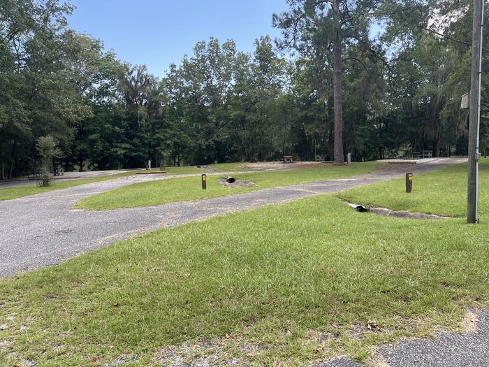 A photo of Site 56 of Loop RFOR at BLUFF CREEK with Picnic Table, Electricity Hookup, Sewer Hookup, Shade, Tent Pad, Full Hookup, Waterfront, Lantern Pole, Water Hookup
