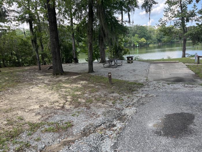 A photo of Site 66 of Loop PBLU at BLUFF CREEK with Picnic Table, Electricity Hookup, Sewer Hookup, Fire Pit, Shade, Tent Pad, Full Hookup, Waterfront, Lantern Pole, Water Hookup