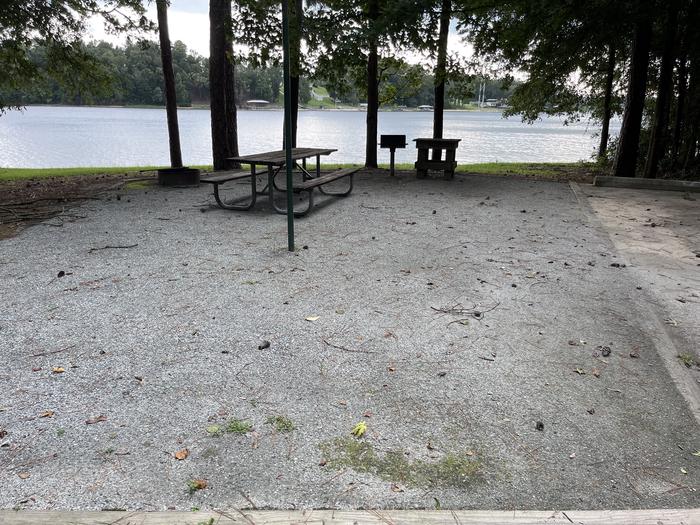 A photo of Site 060 of Loop CVIE at WHITE OAK (CREEK) CAMPGROUND with Picnic Table, Electricity Hookup, Fire Pit, Shade, Waterfront, Water Hookup