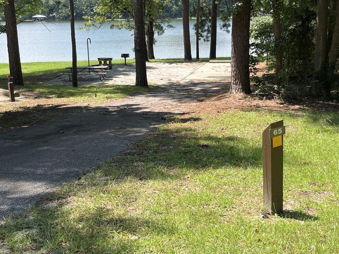A photo of Site 065 of Loop CVIE at WHITE OAK (CREEK) CAMPGROUND with Picnic Table, Electricity Hookup, Fire Pit, Shade, Waterfront, Lantern Pole, Water Hookup