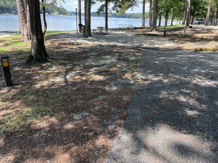 A photo of Site 072 of Loop CVIE at WHITE OAK (CREEK) CAMPGROUND with Picnic Table, Electricity Hookup, Fire Pit, Shade, Waterfront, Lantern Pole, Water Hookup