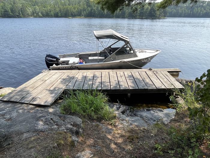 View of dock landing from land with a boat tied to the dock.Dock landing from water