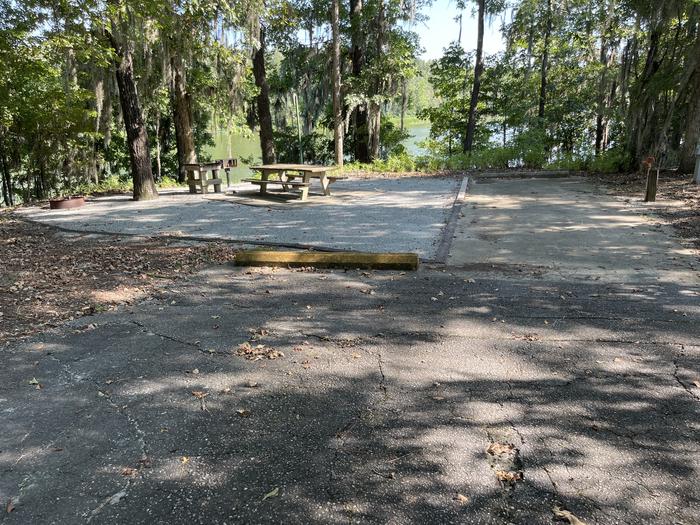 A photo of Site 40 of Loop RFOR at BLUFF CREEK with Picnic Table, Electricity Hookup, Fire Pit, Shade, Waterfront, Lantern Pole, Water Hookup