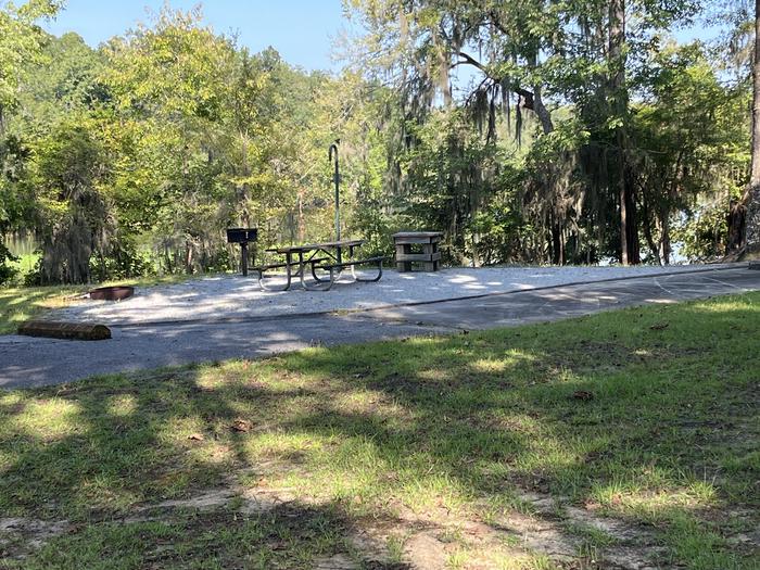 A photo of Site 75 of Loop CLOO at BLUFF CREEK with Picnic Table, Electricity Hookup, Sewer Hookup, Fire Pit, Shade, Food Storage, Tent Pad, Full Hookup, Waterfront, Lantern Pole, Water Hookup