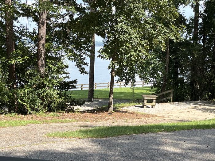 A photo of Site 122 of Loop RCHA at WHITE OAK (CREEK) CAMPGROUND with Picnic Table, Sewer Hookup, Fire Pit, Shade, Tent Pad, Full Hookup, Waterfront, Lantern Pole, Water Hookup