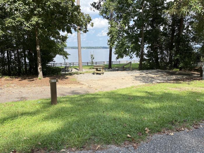 A photo of Site 122 of Loop RCHA at WHITE OAK (CREEK) CAMPGROUND with Picnic Table, Electricity Hookup, Sewer Hookup, Fire Pit, Shade, Tent Pad, Full Hookup, Waterfront, Lantern Pole, Water Hookup