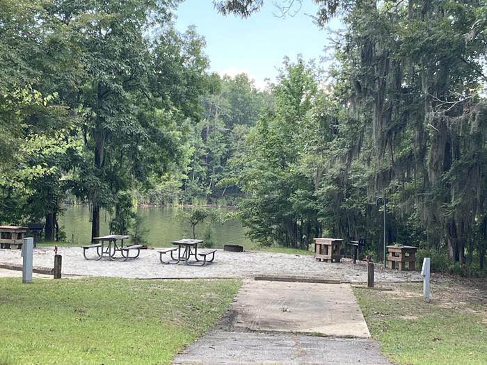 A photo of Site 52/53 of Loop RFOR at BLUFF CREEK with Picnic Table, Electricity Hookup, Sewer Hookup, Fire Pit, Shade, Tent Pad, Full Hookup, Waterfront, Lantern Pole, Water Hookup