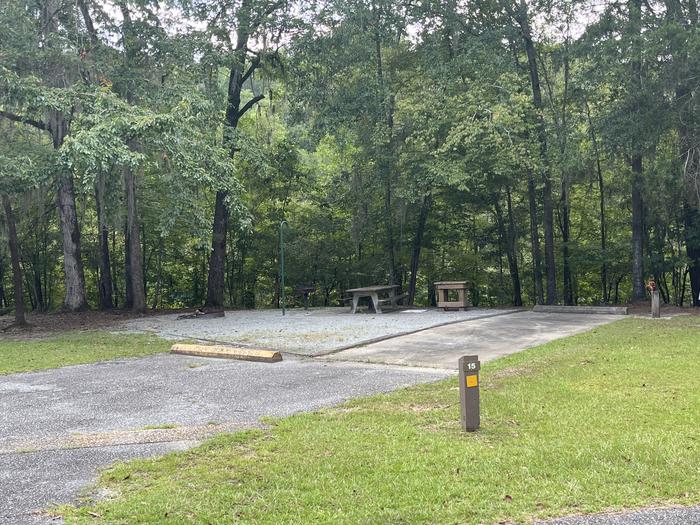 A photo of Site 15 of Loop MRUN at BLUFF CREEK with Picnic Table, Electricity Hookup, Sewer Hookup, Fire Pit, Shade, Tent Pad, Full Hookup, Waterfront, Lantern Pole, Water Hookup