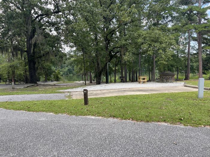 A photo of Site 69 of Loop PBLU at BLUFF CREEK with Picnic Table, Electricity Hookup, Sewer Hookup, Fire Pit, Tent Pad, Full Hookup, Waterfront, Lantern Pole, Water Hookup