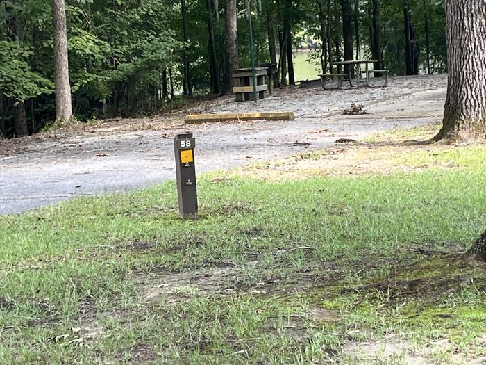 A photo of Site 58 of Loop RFOR at BLUFF CREEK with Picnic Table, Electricity Hookup, Sewer Hookup, Fire Pit, Shade, Tent Pad, Full Hookup, Lantern Pole, Water Hookup