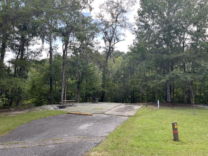 A photo of Site 16 of Loop MRUN at BLUFF CREEK with Picnic Table, Electricity Hookup, Sewer Hookup, Fire Pit, Shade, Tent Pad, Full Hookup, Waterfront, Lantern Pole, Water Hookup