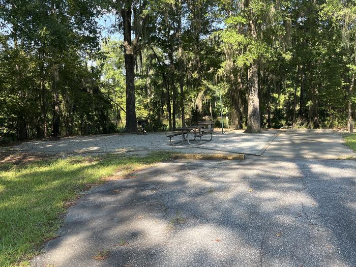 A photo of Site 82 of Loop CLOO at BLUFF CREEK with Picnic Table, Electricity Hookup, Sewer Hookup, Fire Pit, Shade, Food Storage, Tent Pad, Full Hookup, Waterfront, Lantern Pole, Water Hookup